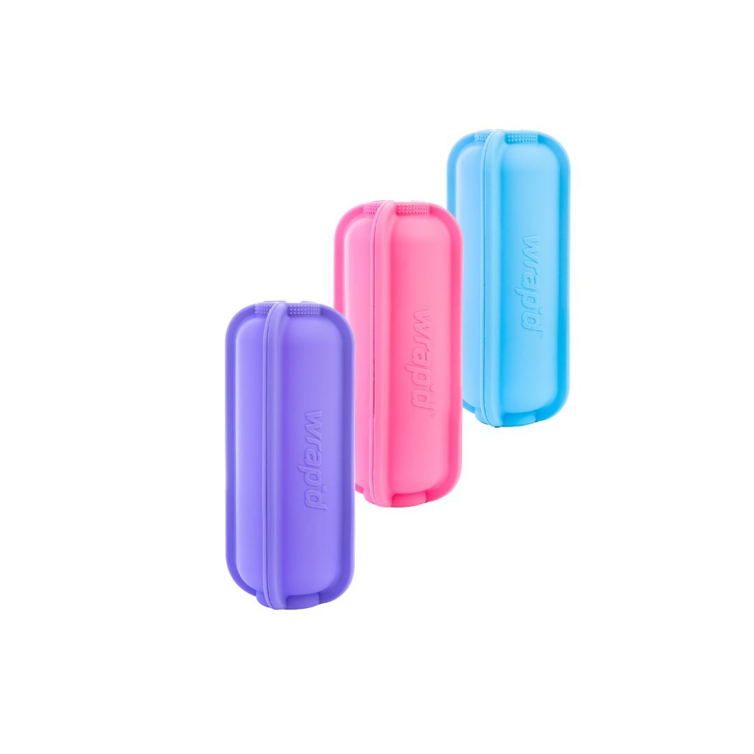 Three colourful cases for holding wraps (purple, pink, blue) with 'Wrap'd' branding on a white background.