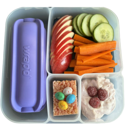 Fresh lunch with a purple Wrap'd inside a bento style lunchbox
